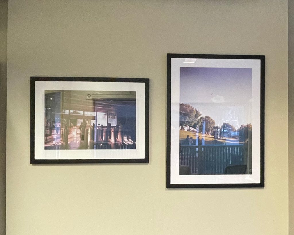 two framed photos mounted on a wall