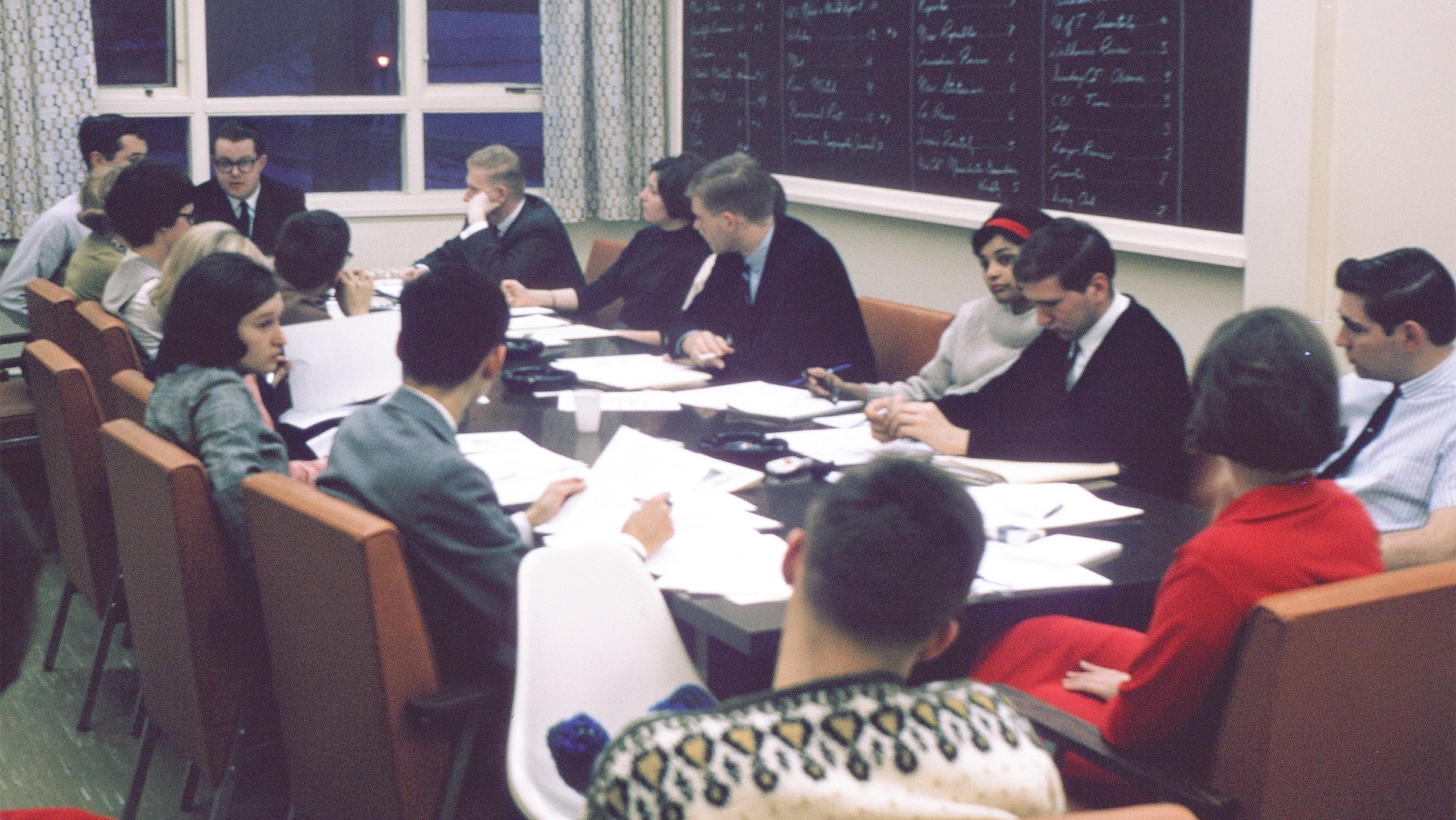 1960s students sit around a board room table