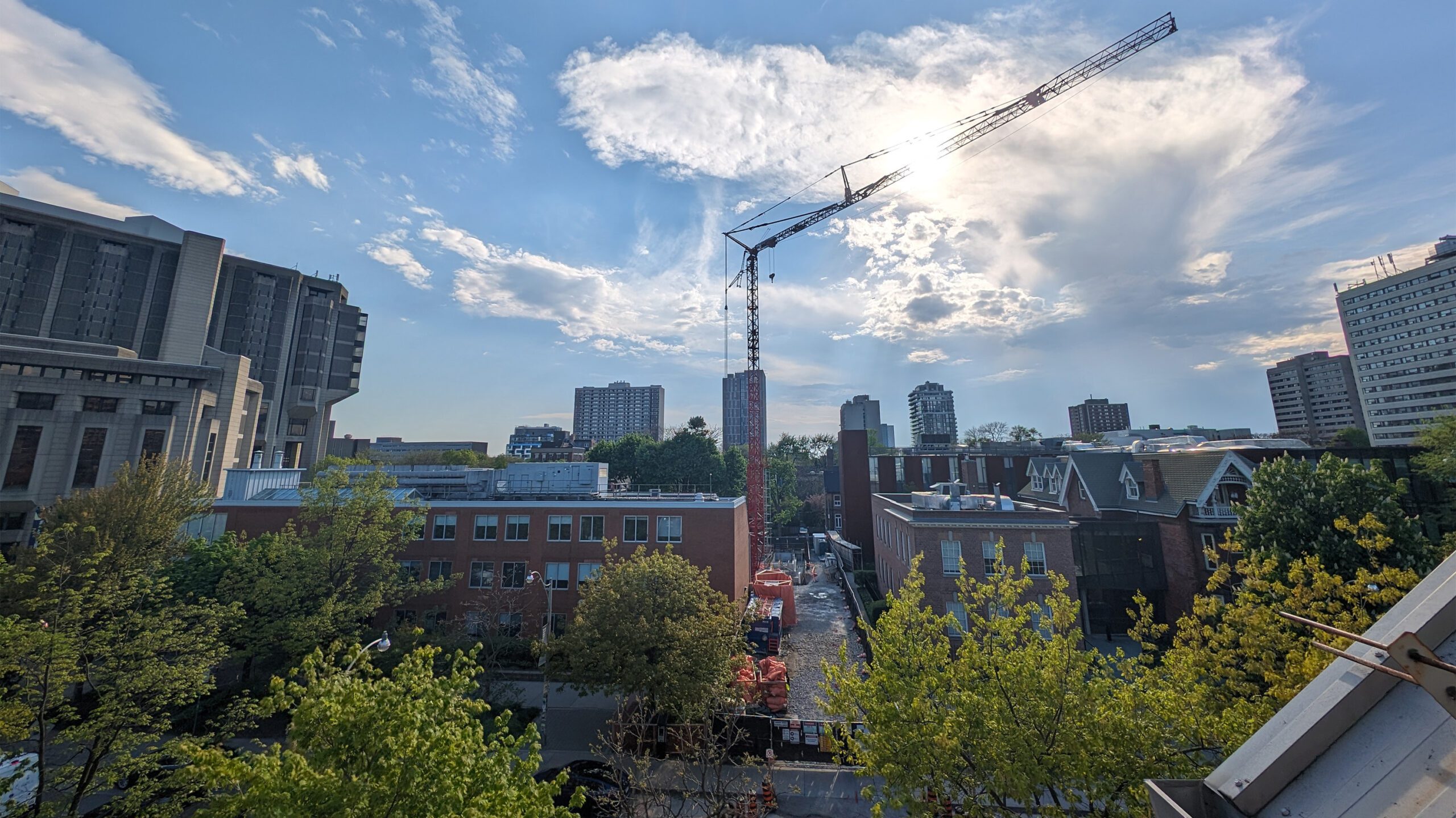 west-facing view of Innis College, as seen from upper-level of Innis Residence, showing construction crane.