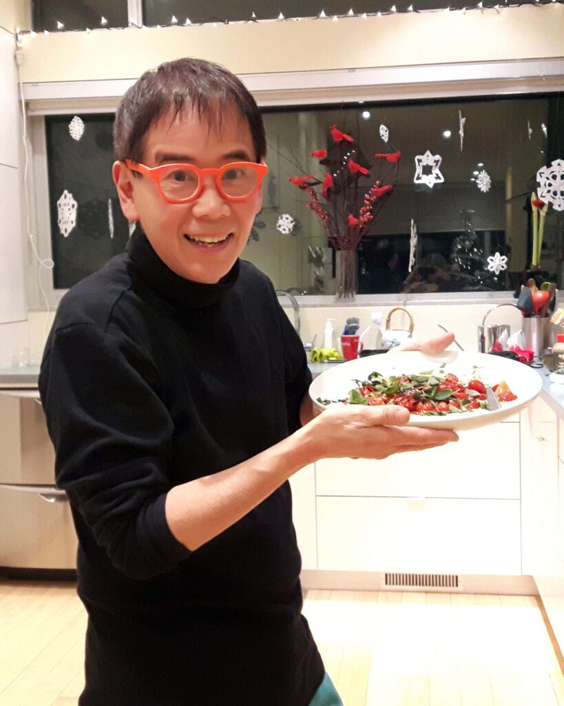 john ota displays a plate of food in his home kitchen
