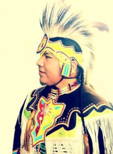 An Anishnaabe man in pow-wow regalia